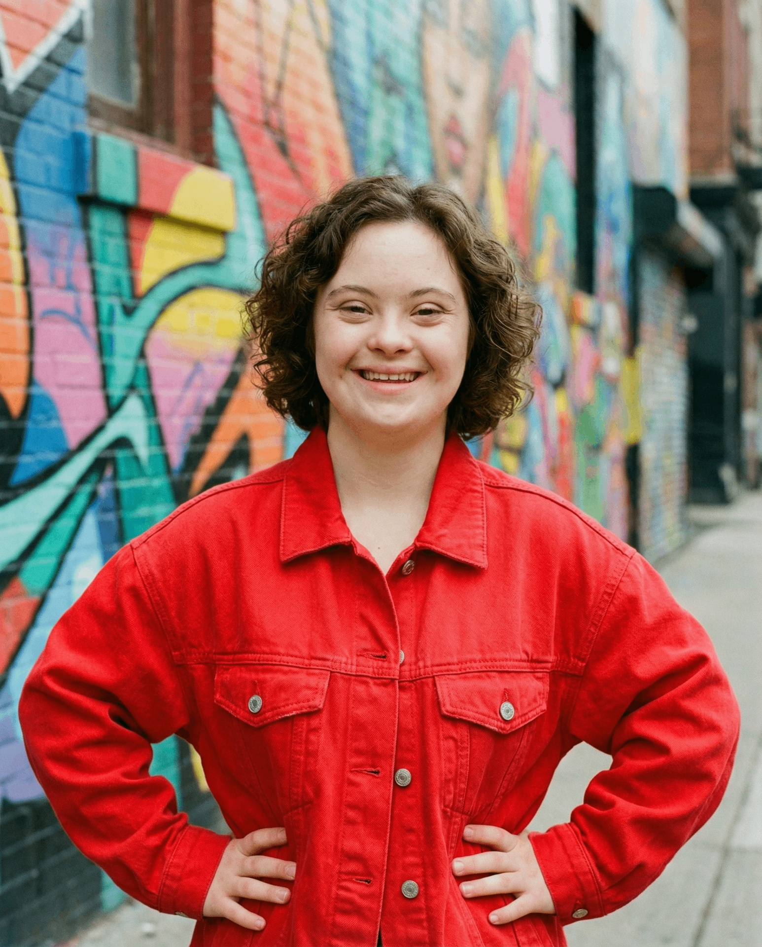 A happy person looking at their phone and smiling.